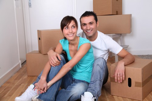 Local movers carrying furniture through a Tooting home