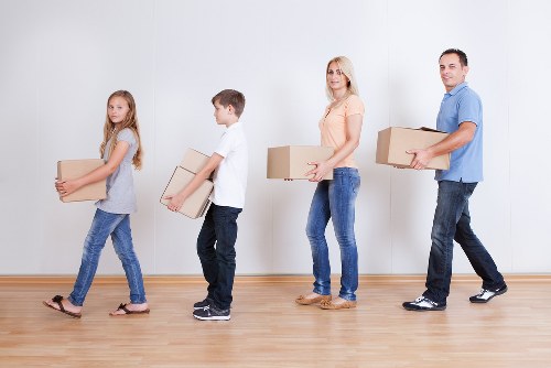 Local moving truck loading household furniture in South West London
