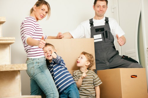 Local moving team handling furniture near a Tooting flat